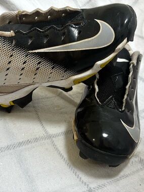 Nike Black and White Athletic Cleats with Gold Trim